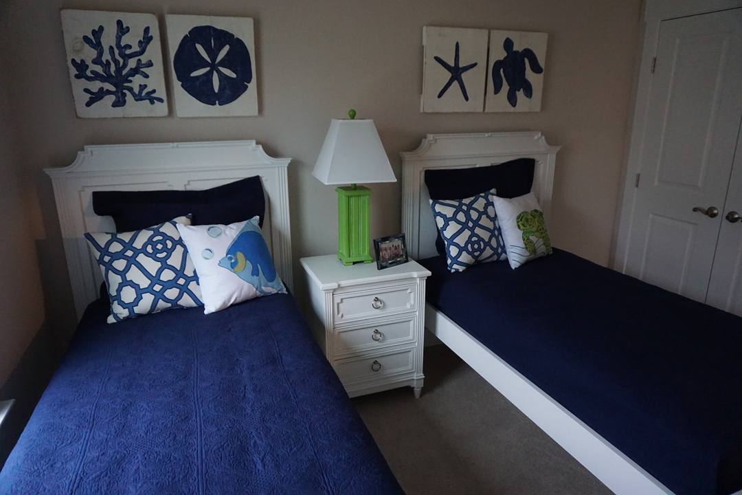 two twin beds with blue covers and pillows