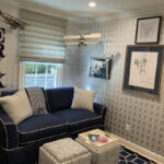Thumbnail of http://a%20living%20room%20with%20a%20blue%20couch%20and%20ottoman