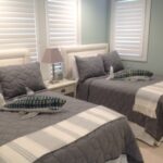 Thumbnail of http://two%20beds%20in%20a%20room%20with%20white%20and%20gray%20bedding