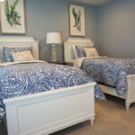 Thumbnail of http://two%20beds%20in%20a%20bedroom%20with%20blue%20and%20white%20bedding