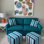 Thumbnail of http://a%20blue%20couch%20and%20ottoman%20in%20a%20living%20room