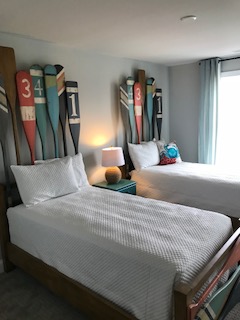 two beds in a room with skis on the wall