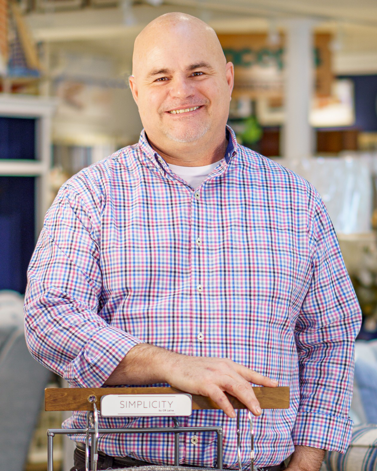 a man standing next to a couch in a room