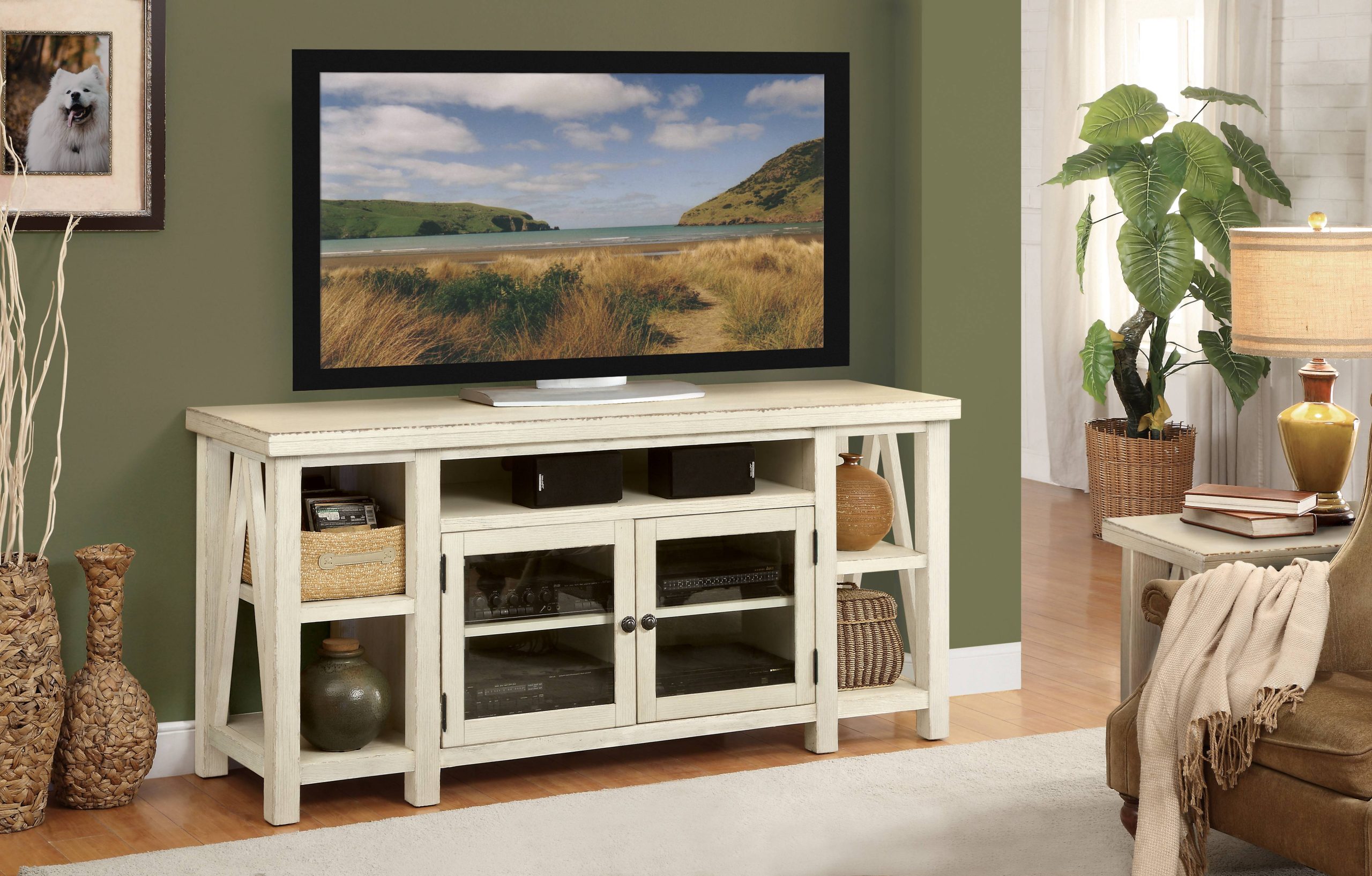 a flat screen tv sitting on top of a white entertainment center