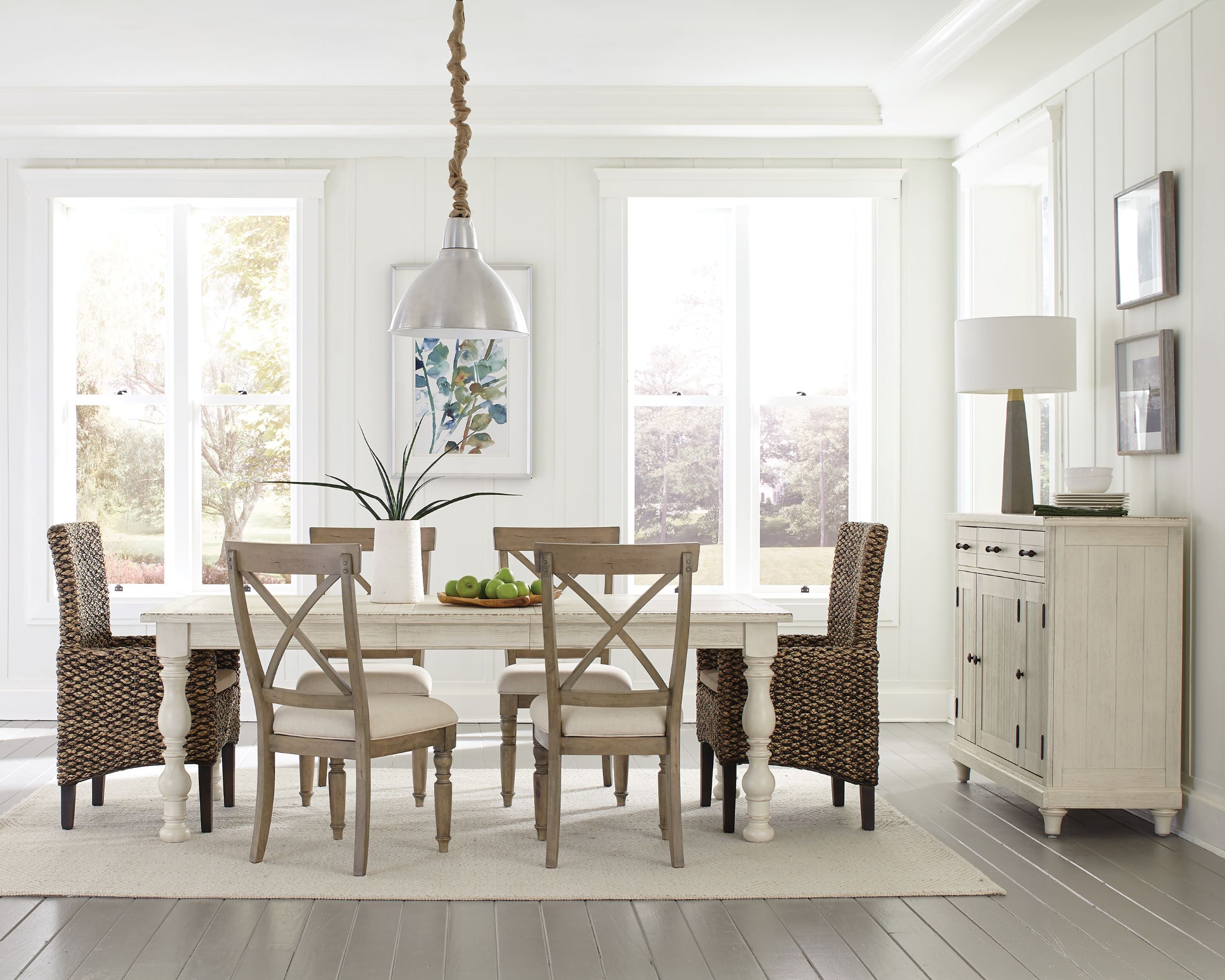 a dining room table with chairs and a white rug