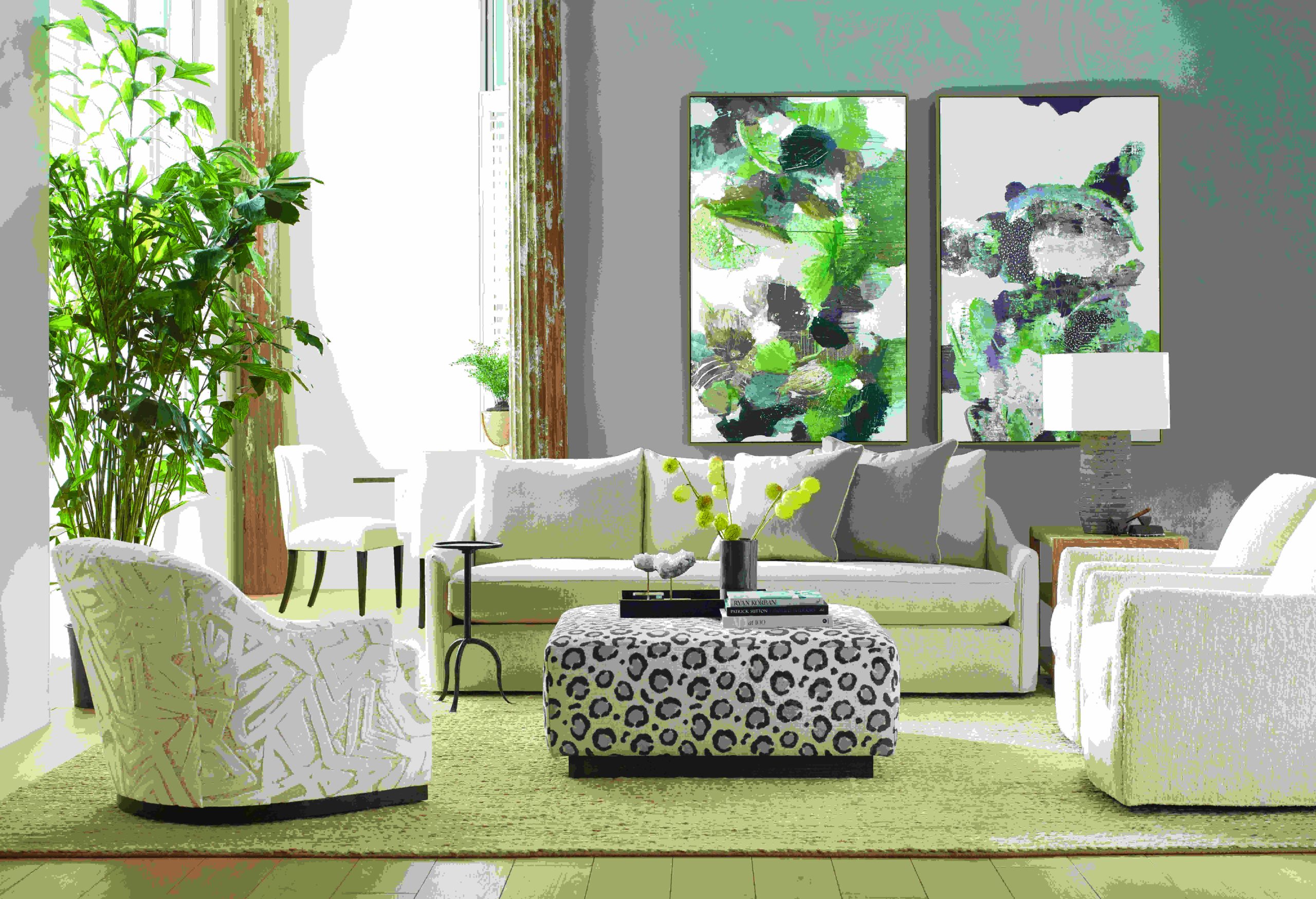 a living room filled with white furniture and green walls
