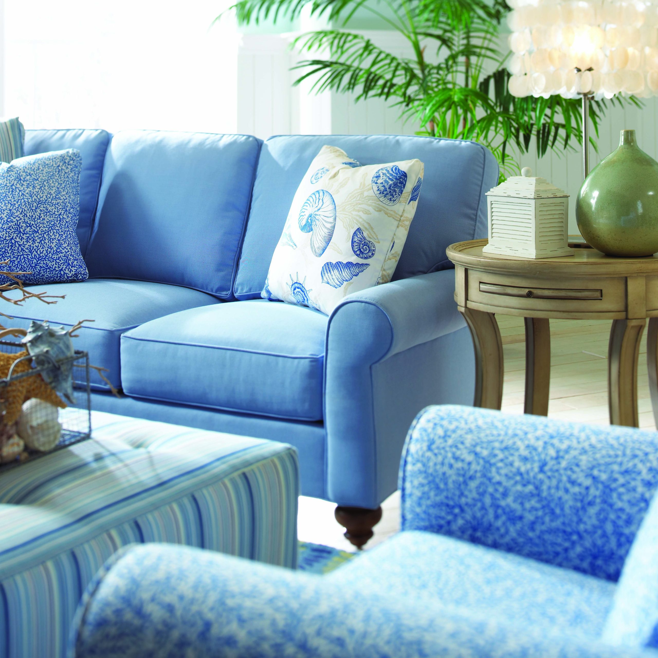 a living room with blue couches and chairs