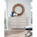 Thumbnail of http://a%20white%20dresser%20with%20a%20round%20mirror%20above%20it