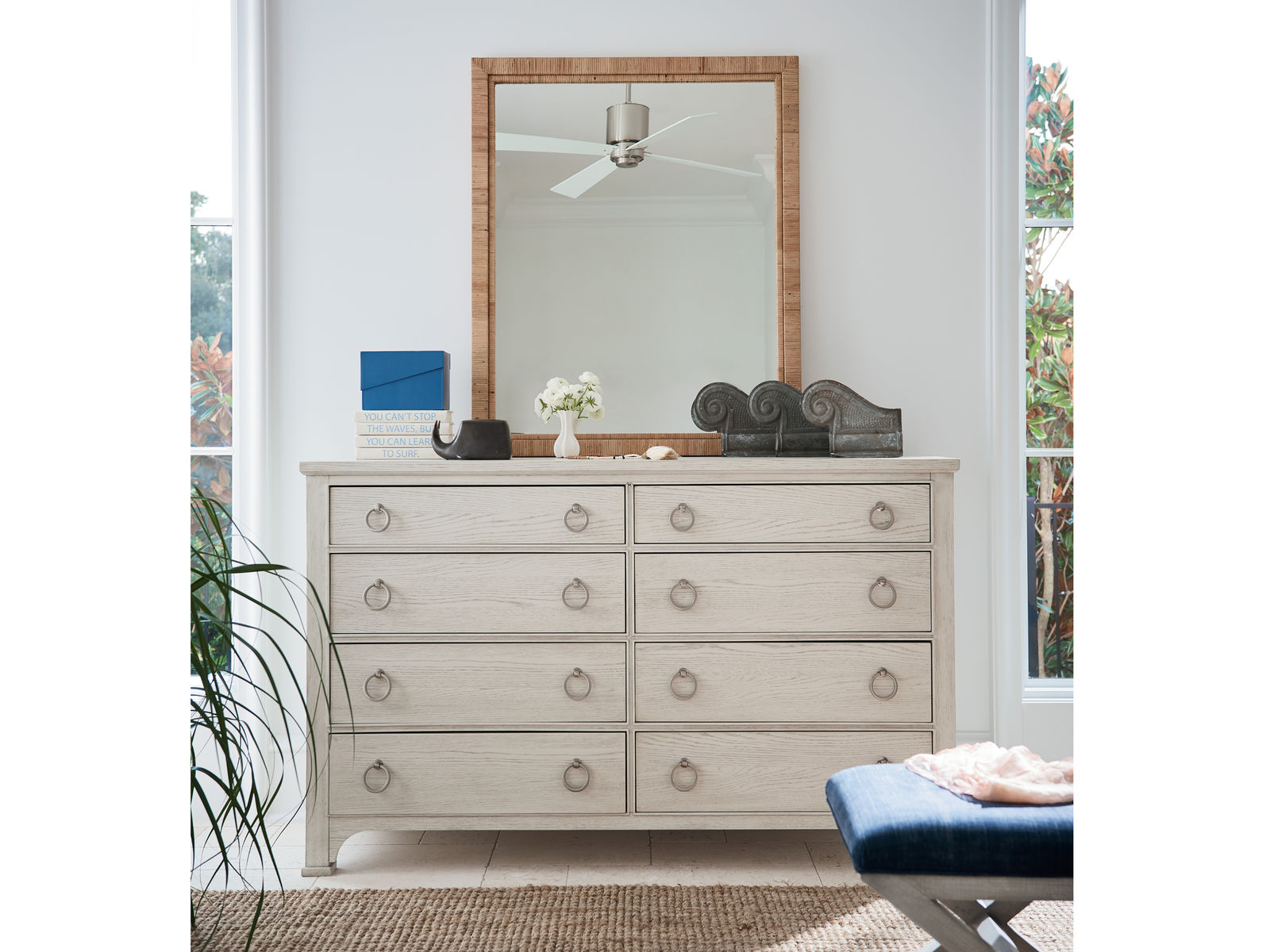 a white dresser with a mirror on top of it