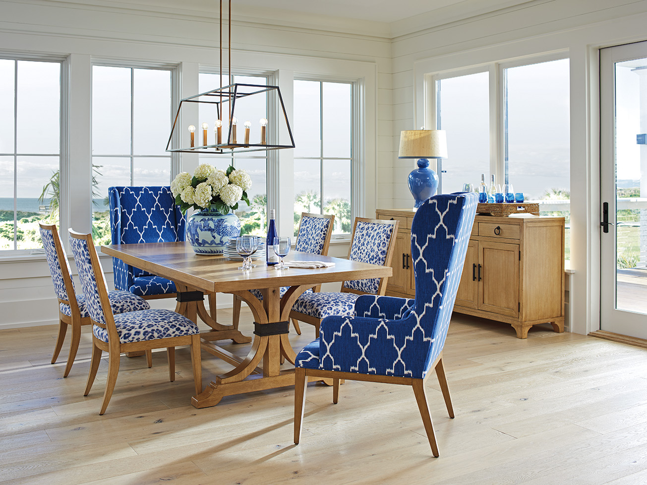 a dining room table with blue and white chairs