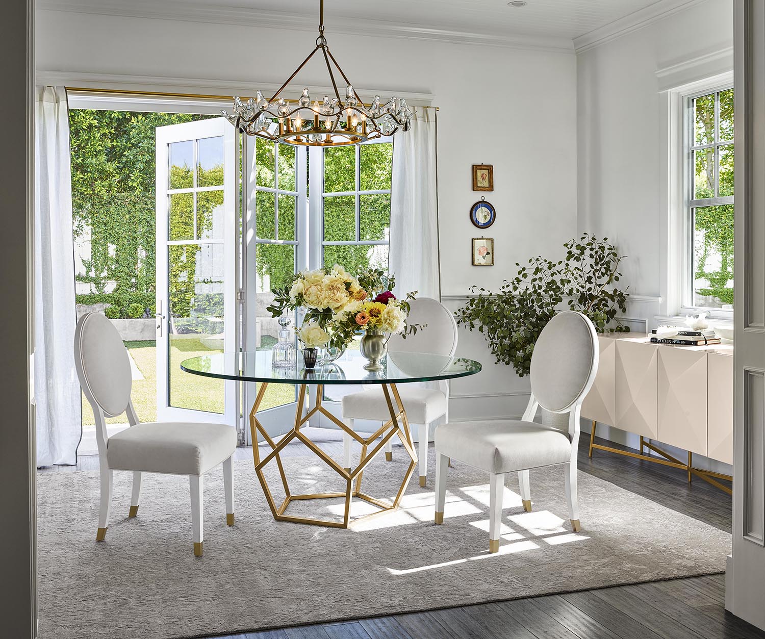 a dining room table with white chairs and a glass top