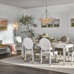 Thumbnail of http://a%20dining%20room%20table%20with%20white%20chairs%20and%20a%20chandelier