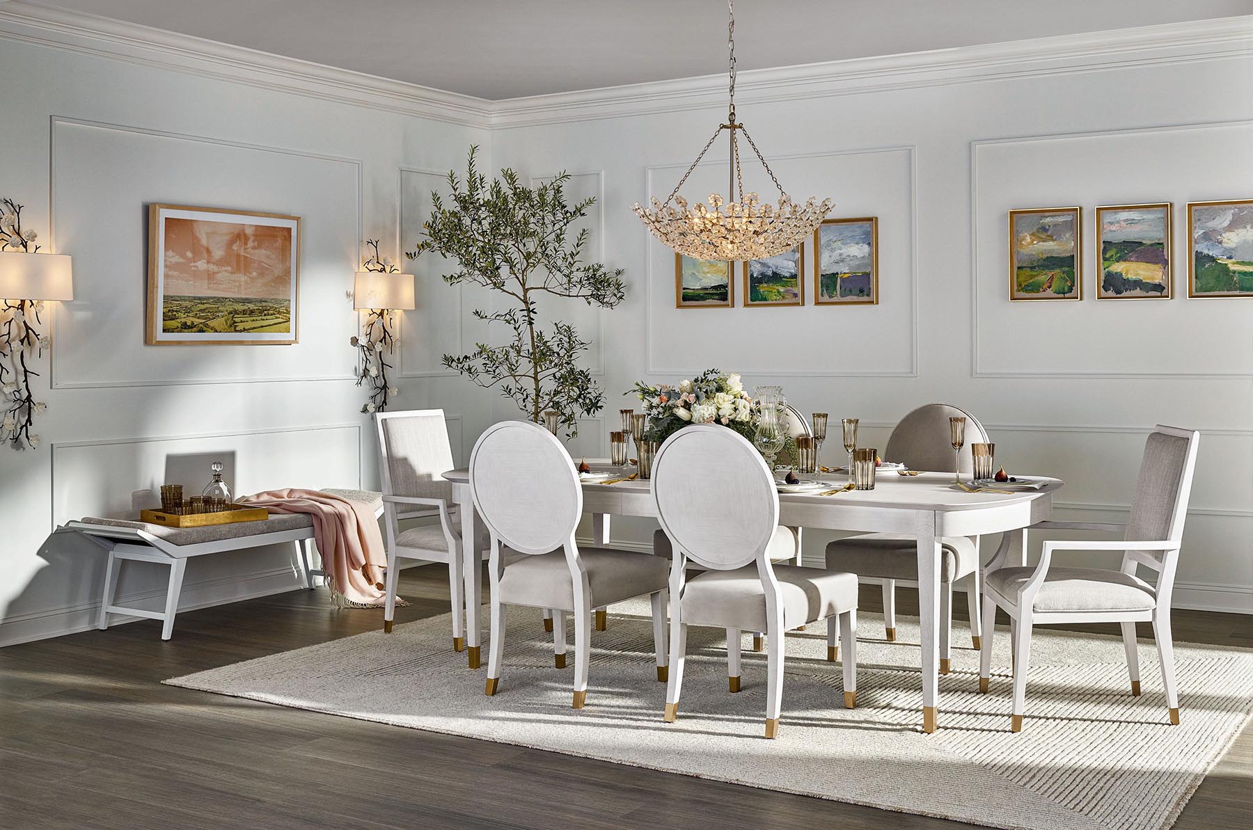 a dining room table with white chairs and a chandelier