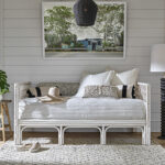 Thumbnail of http://a%20white%20day%20bed%20sitting%20in%20a%20living%20room%20next%20to%20a%20lamp