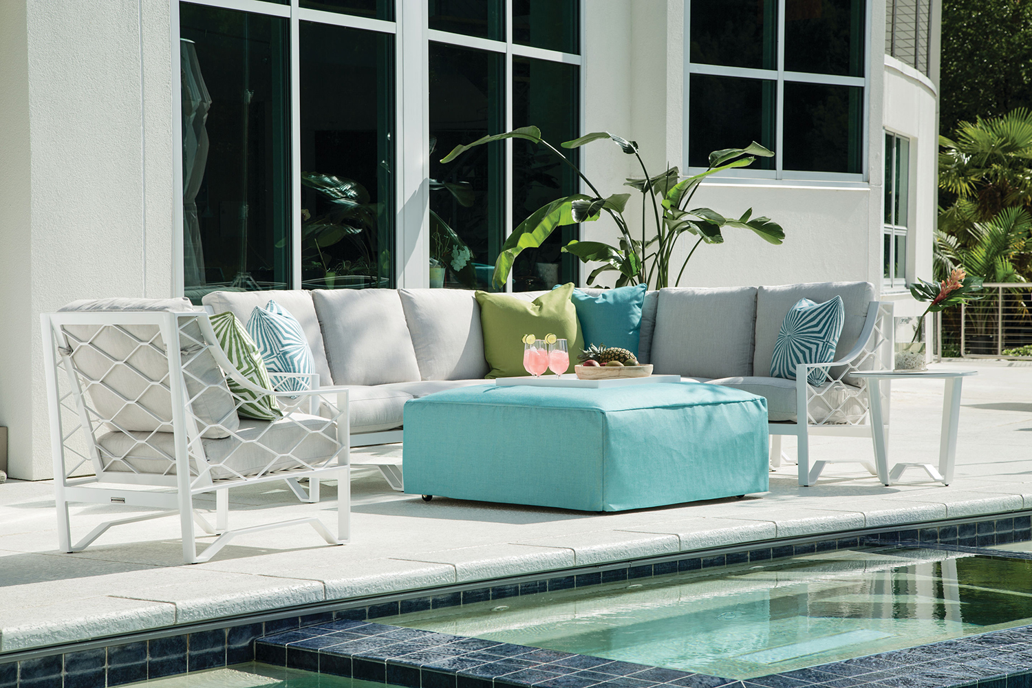 a couch sitting next to a swimming pool