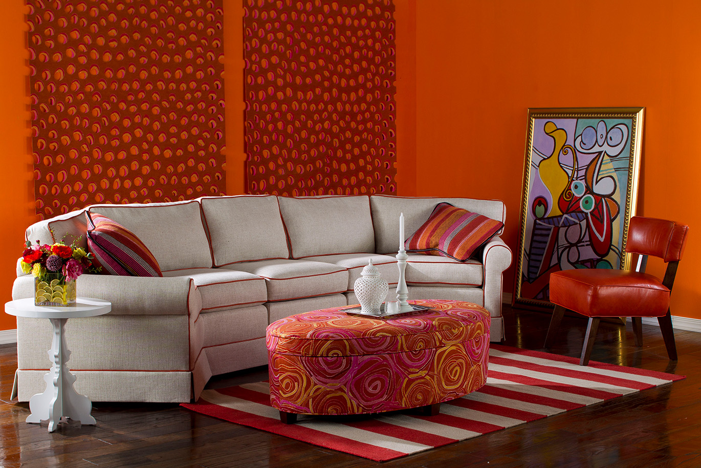 a living room with orange walls and furniture