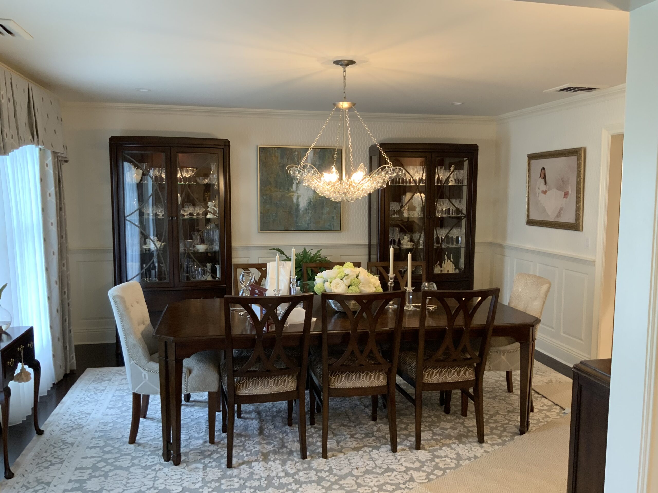 a dinning room table with chairs and a chandelier