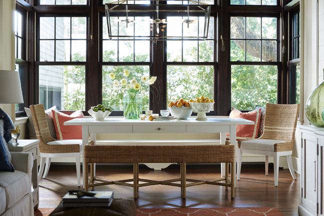 a dining room table with chairs and vases on it