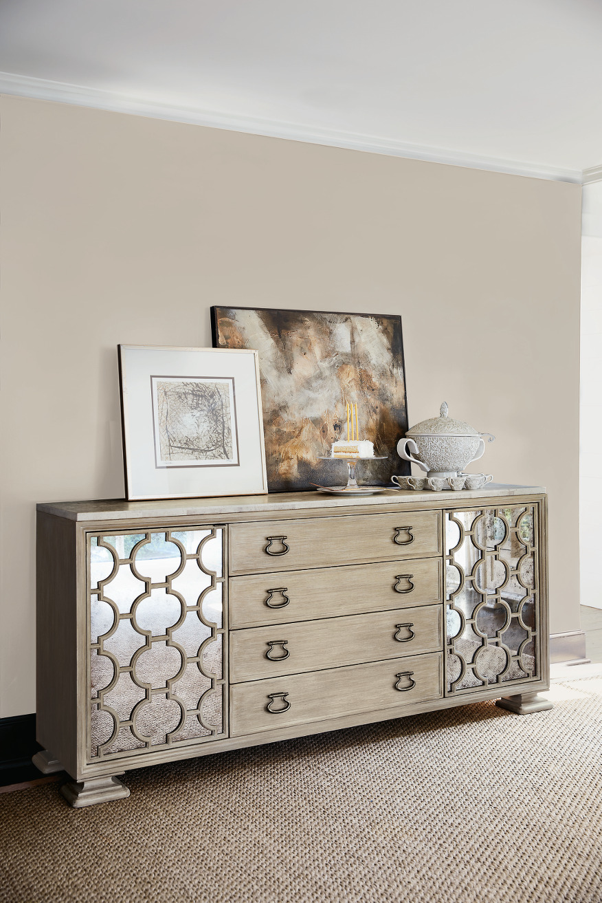 a silver dresser with pictures on top of it