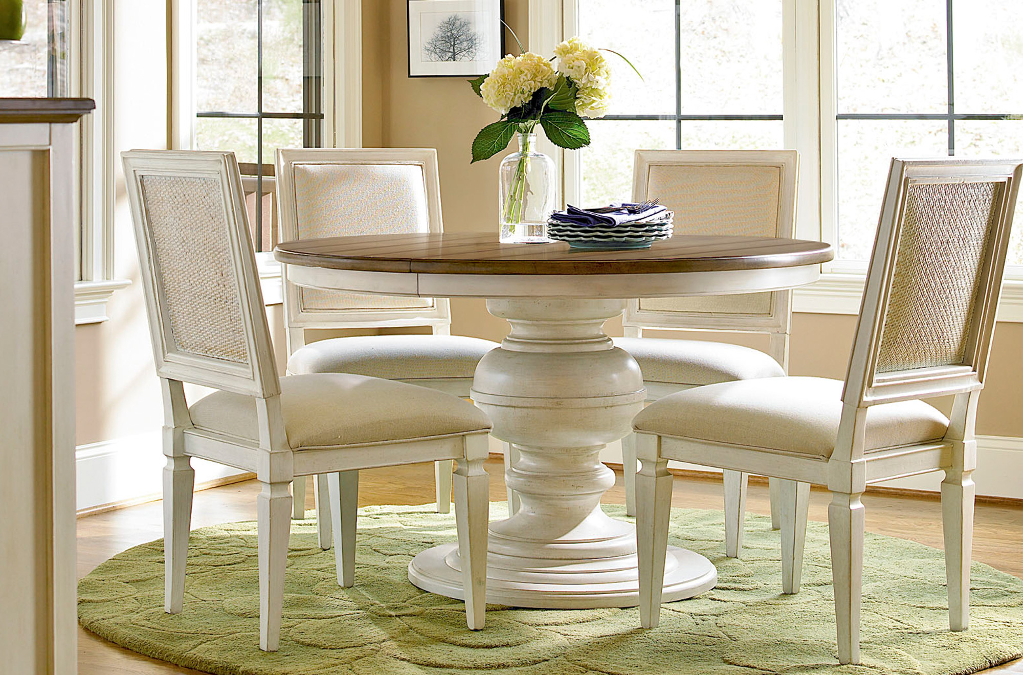 a white table with four chairs around it