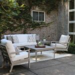 Thumbnail of http://a%20white%20couch%20and%20chair%20sitting%20on%20top%20of%20a%20patio