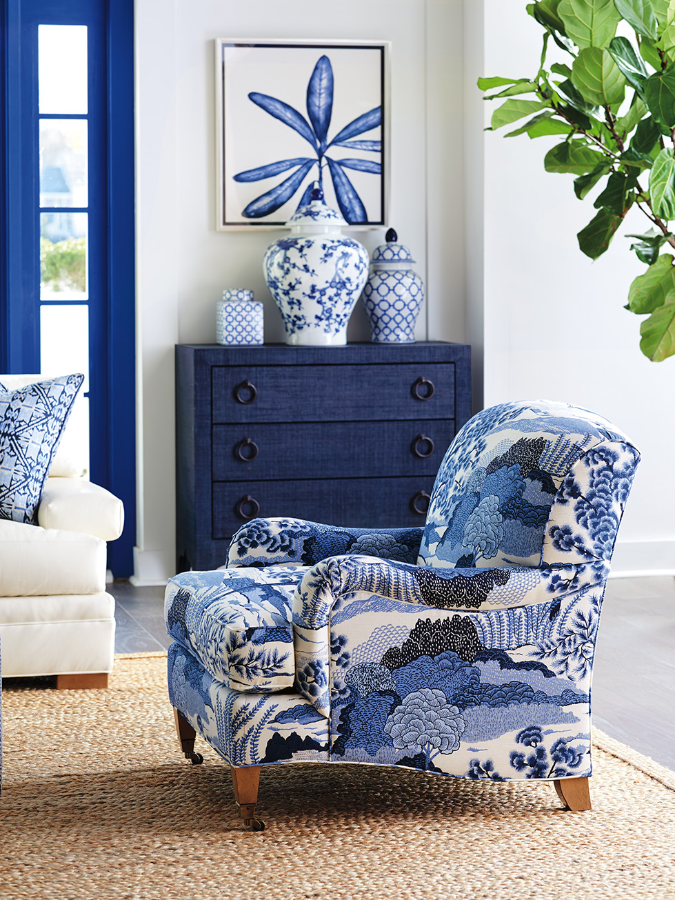 a blue and white chair in a living room