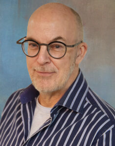 a man with glasses and a striped shirt