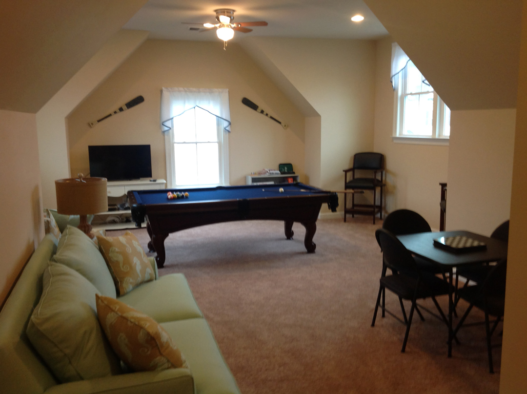 a living room with a pool table in it