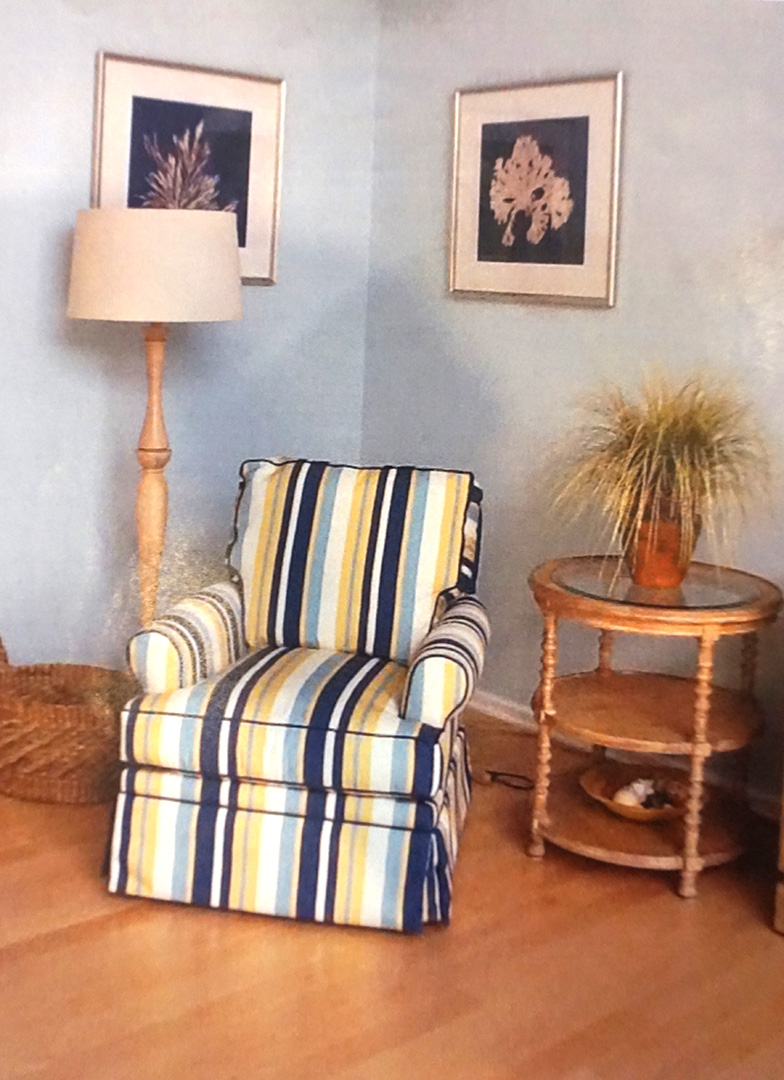 a living room with blue walls and striped furniture