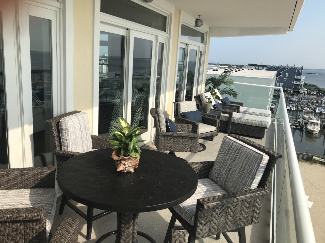 a table and chairs on a balcony overlooking the water