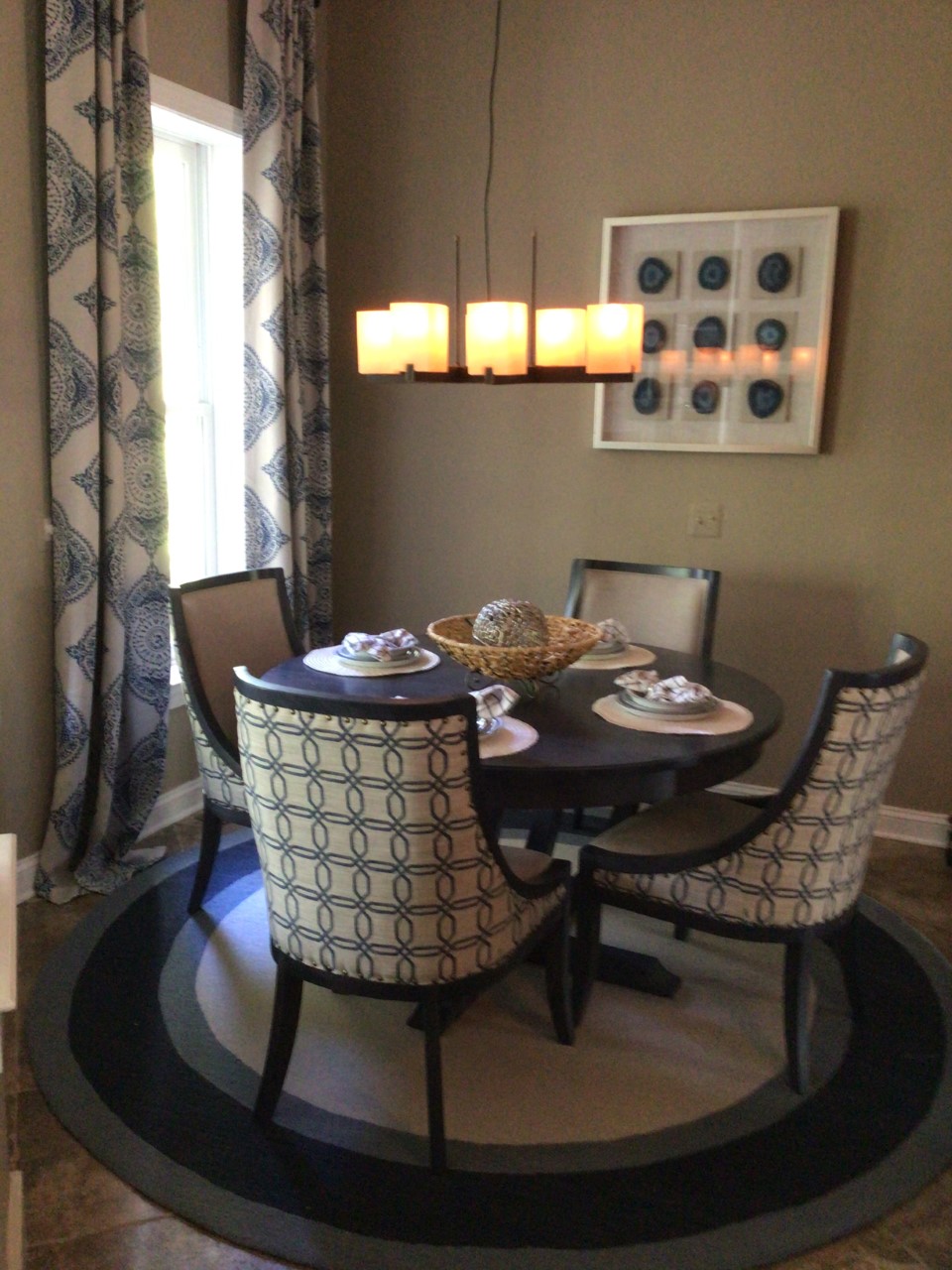 a dinning room table with chairs around it