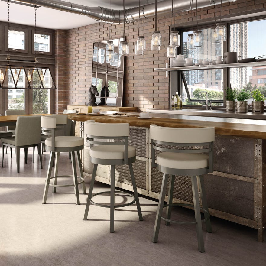 a brick wall kitchen with bar stools and an island