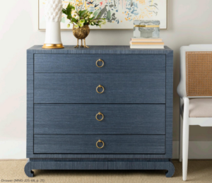 a blue dresser with gold handles in a room