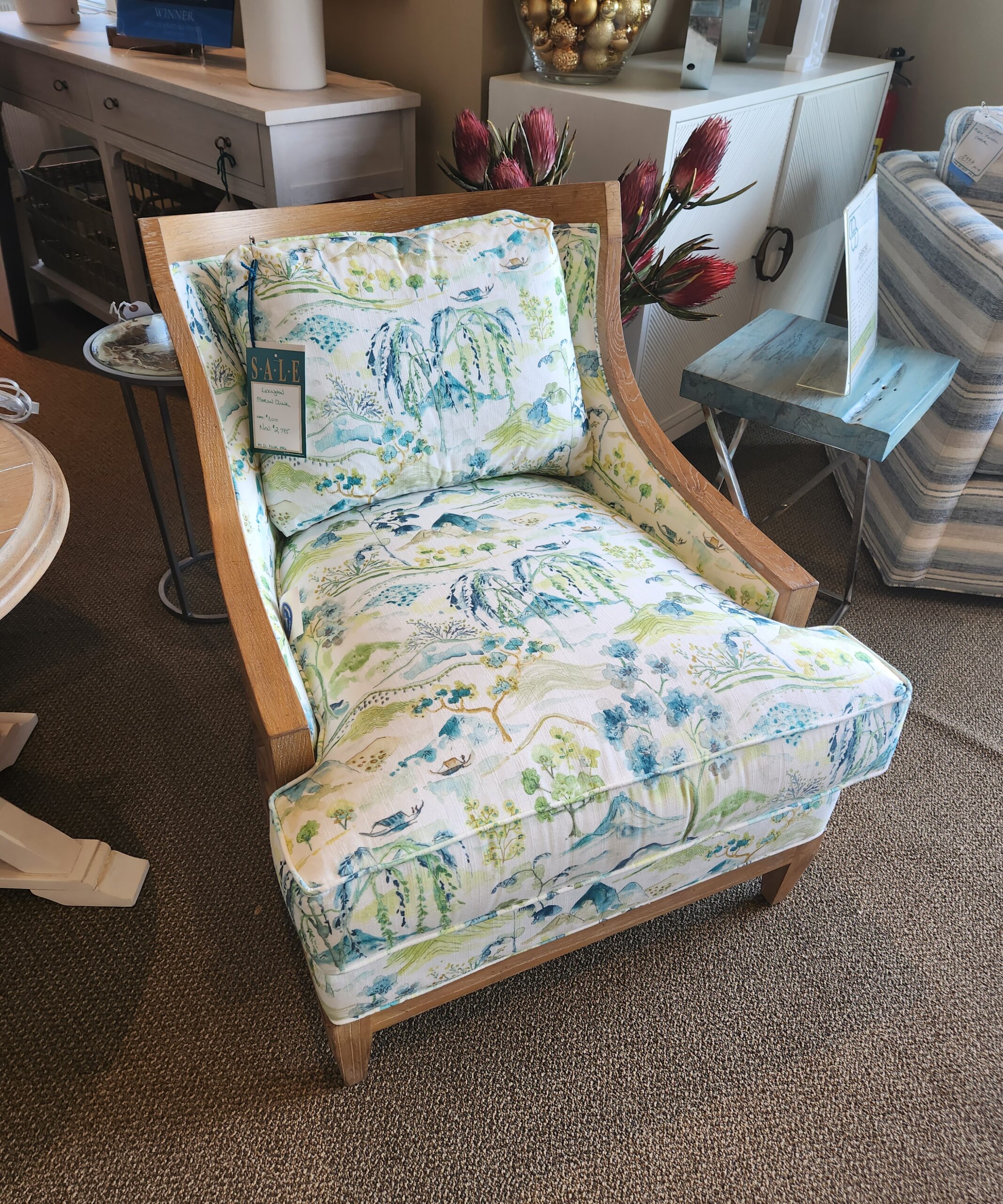 a chair with a blue and green floral pattern on it