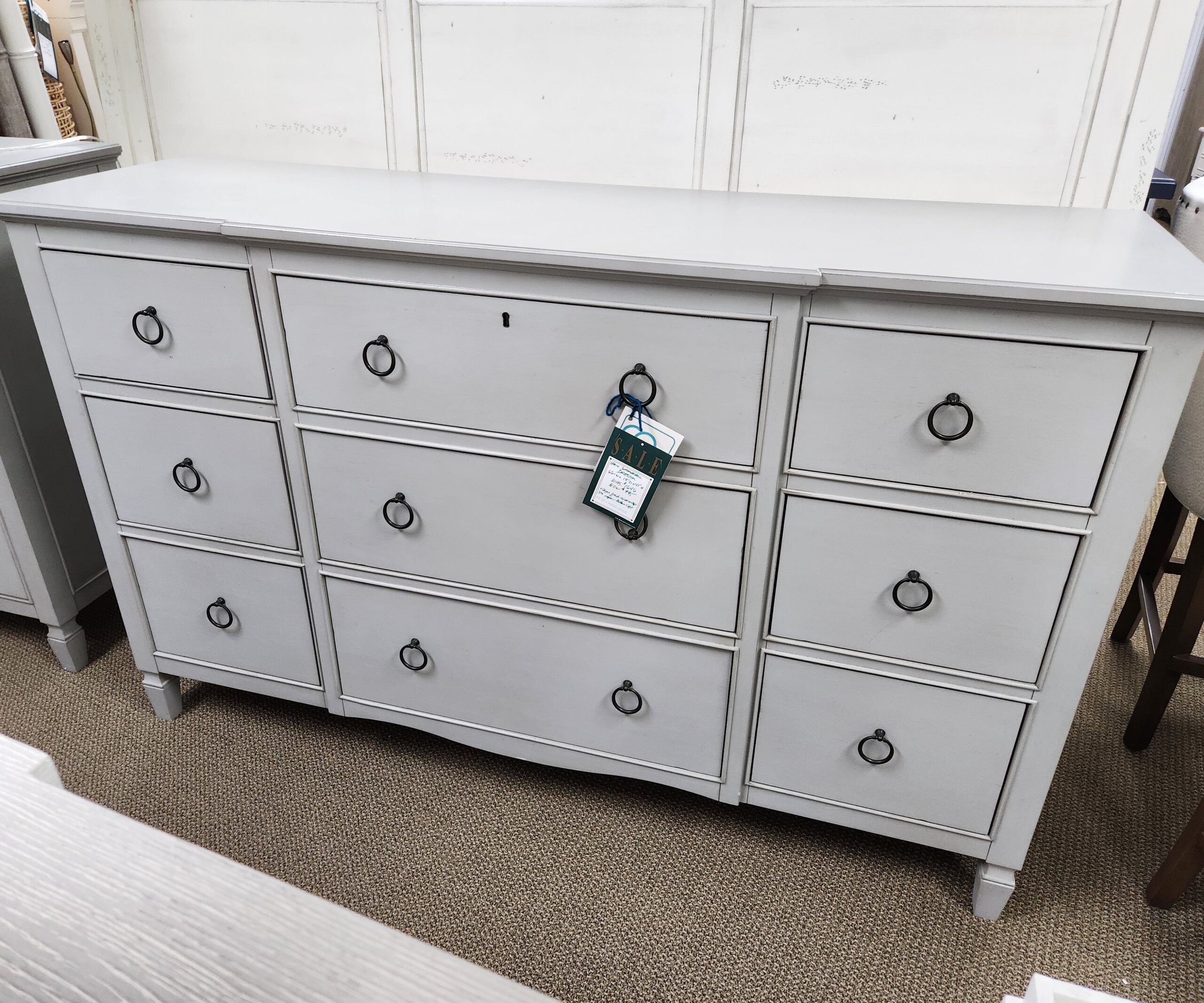 a white dresser with several drawers on top of it