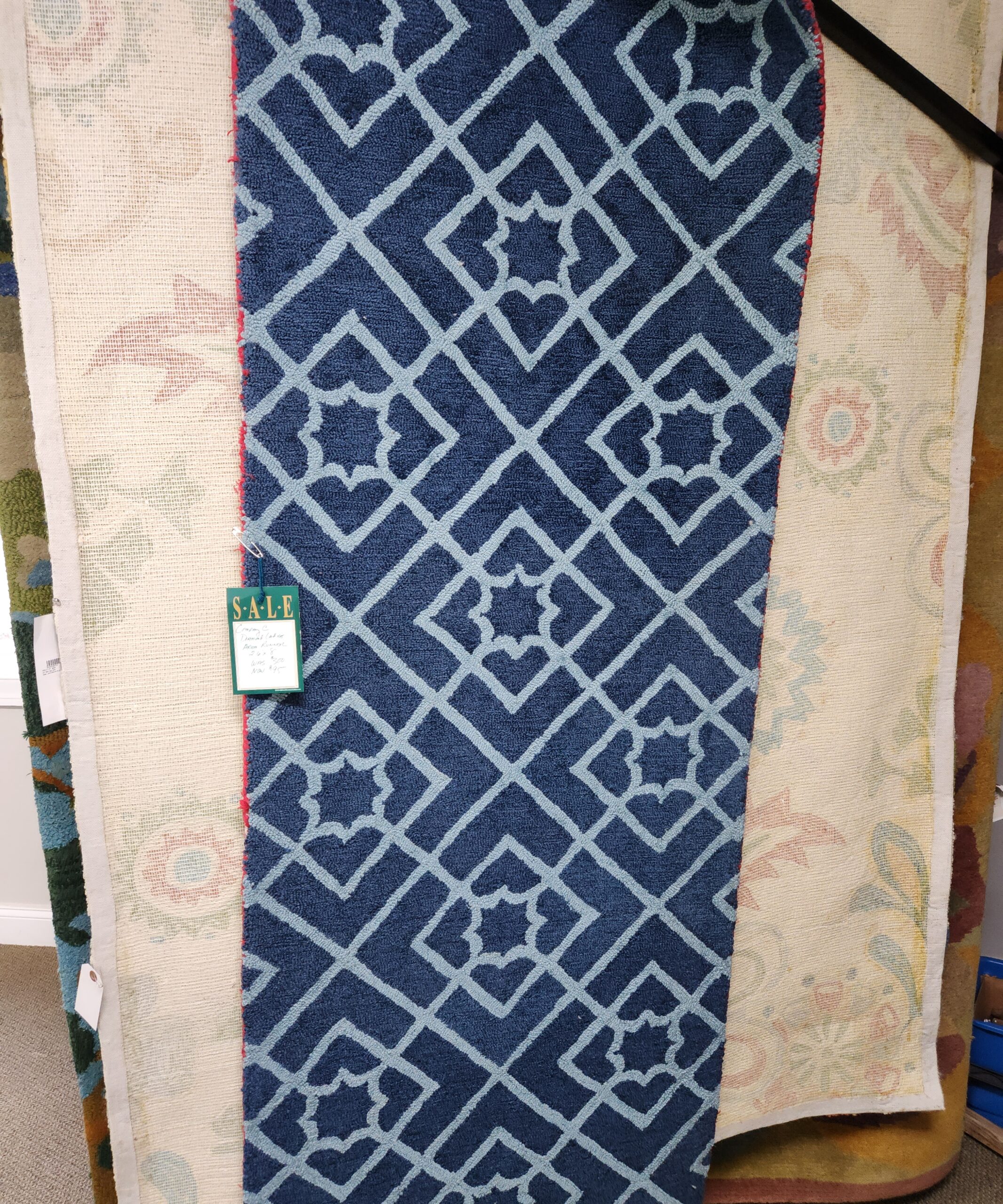 a blue and white rug with a tag on it