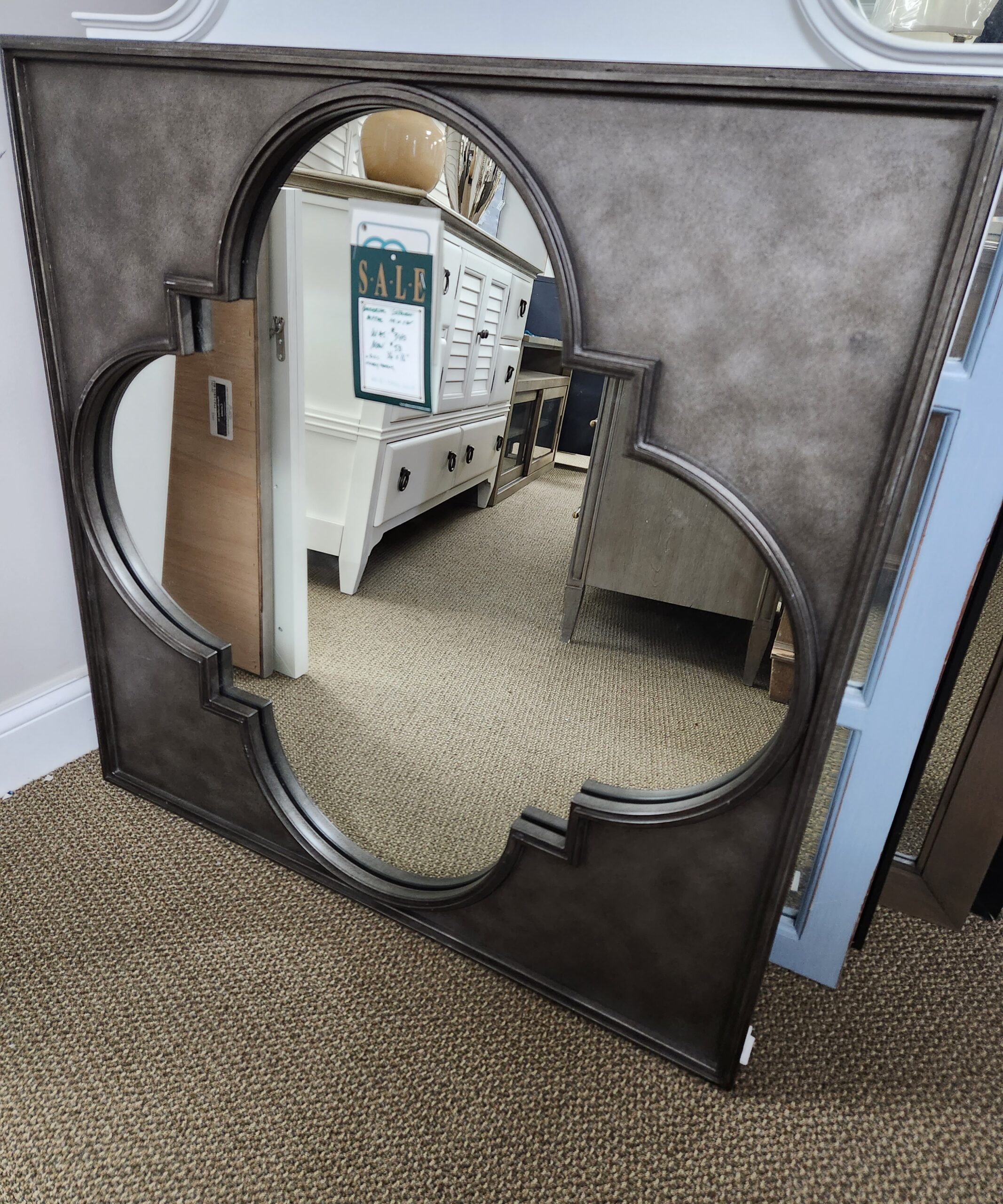 a mirror with a computer on top of it