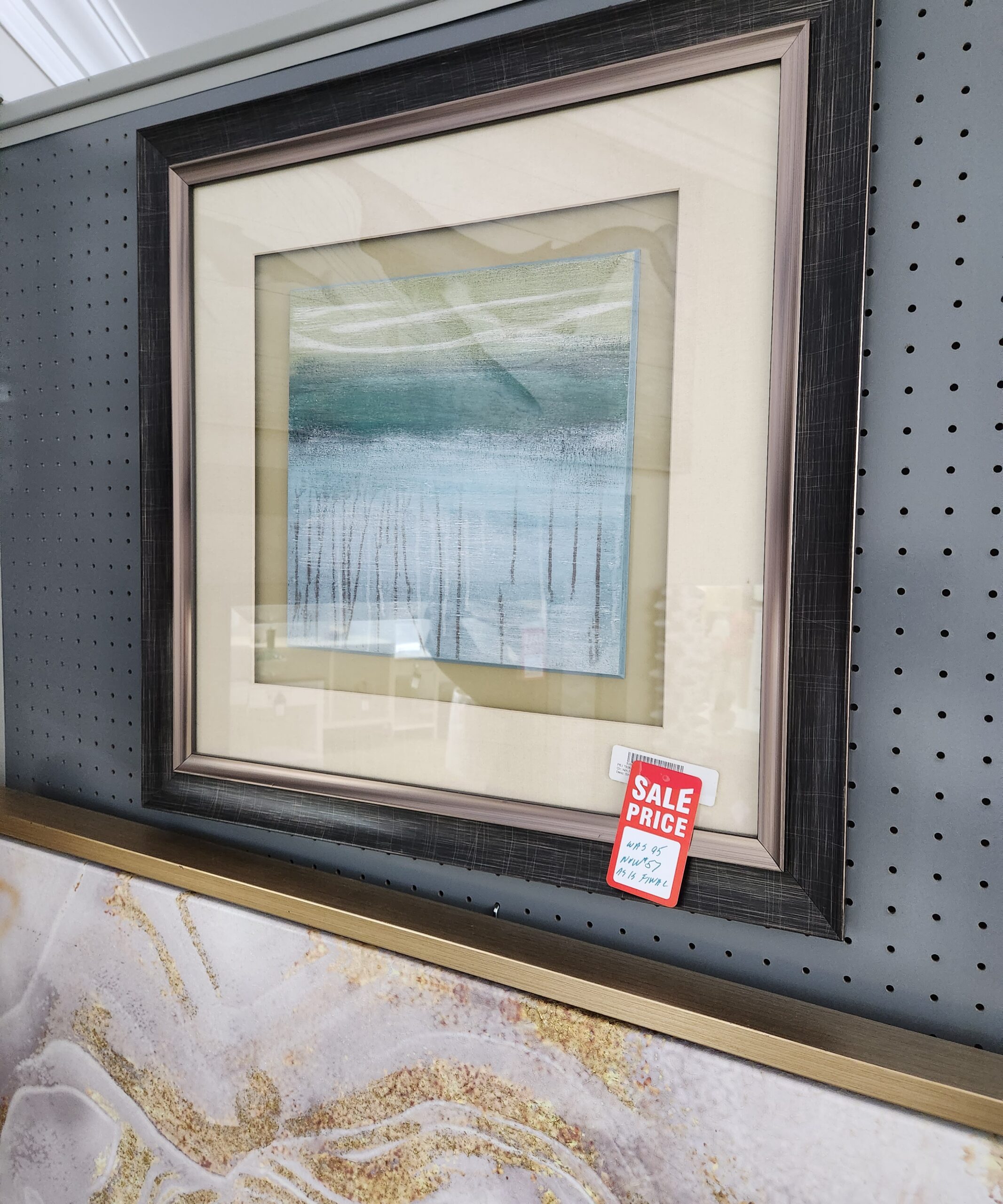 a framed painting on display in a store
