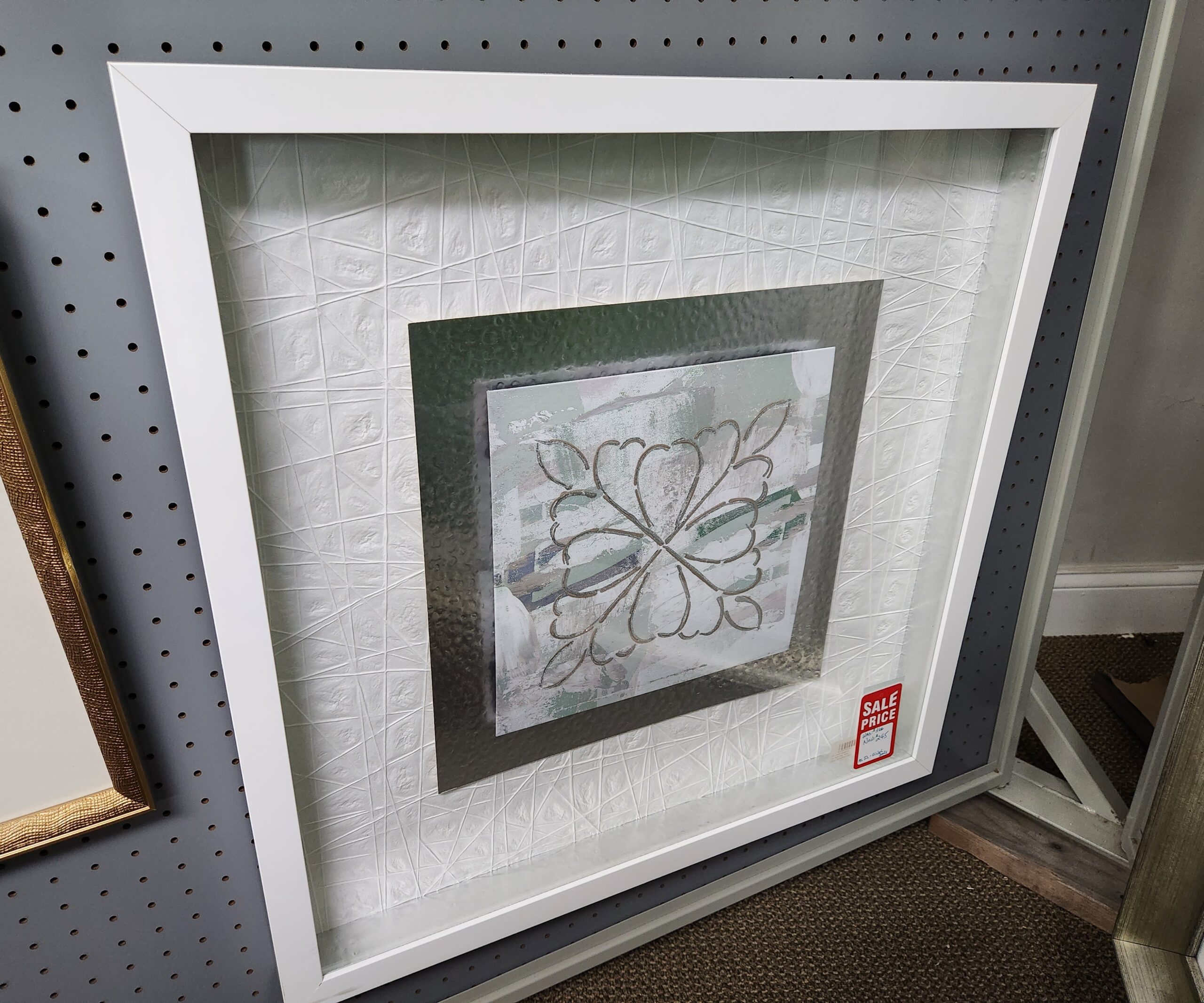 a picture frame with a white flower on it