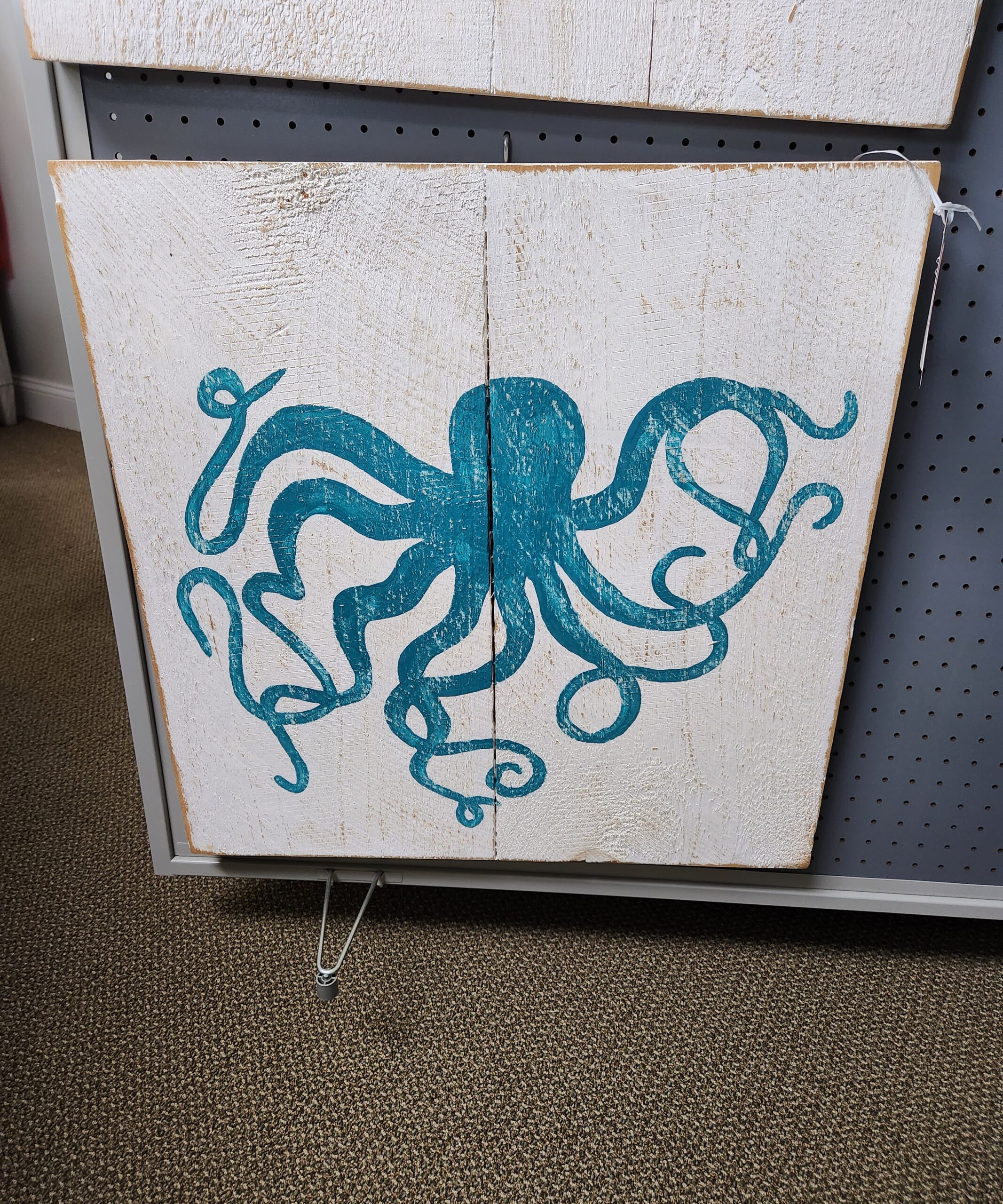an octopus is painted on a piece of wood