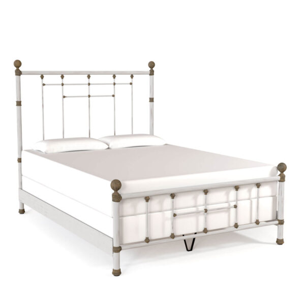 a white bed with metal headboard and foot board