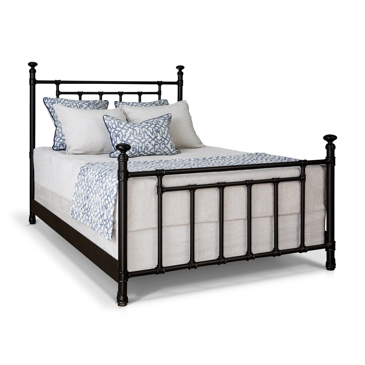 a black metal bed frame with white pillows