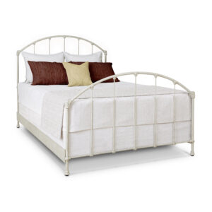 a bed with white metal frame and brown pillows