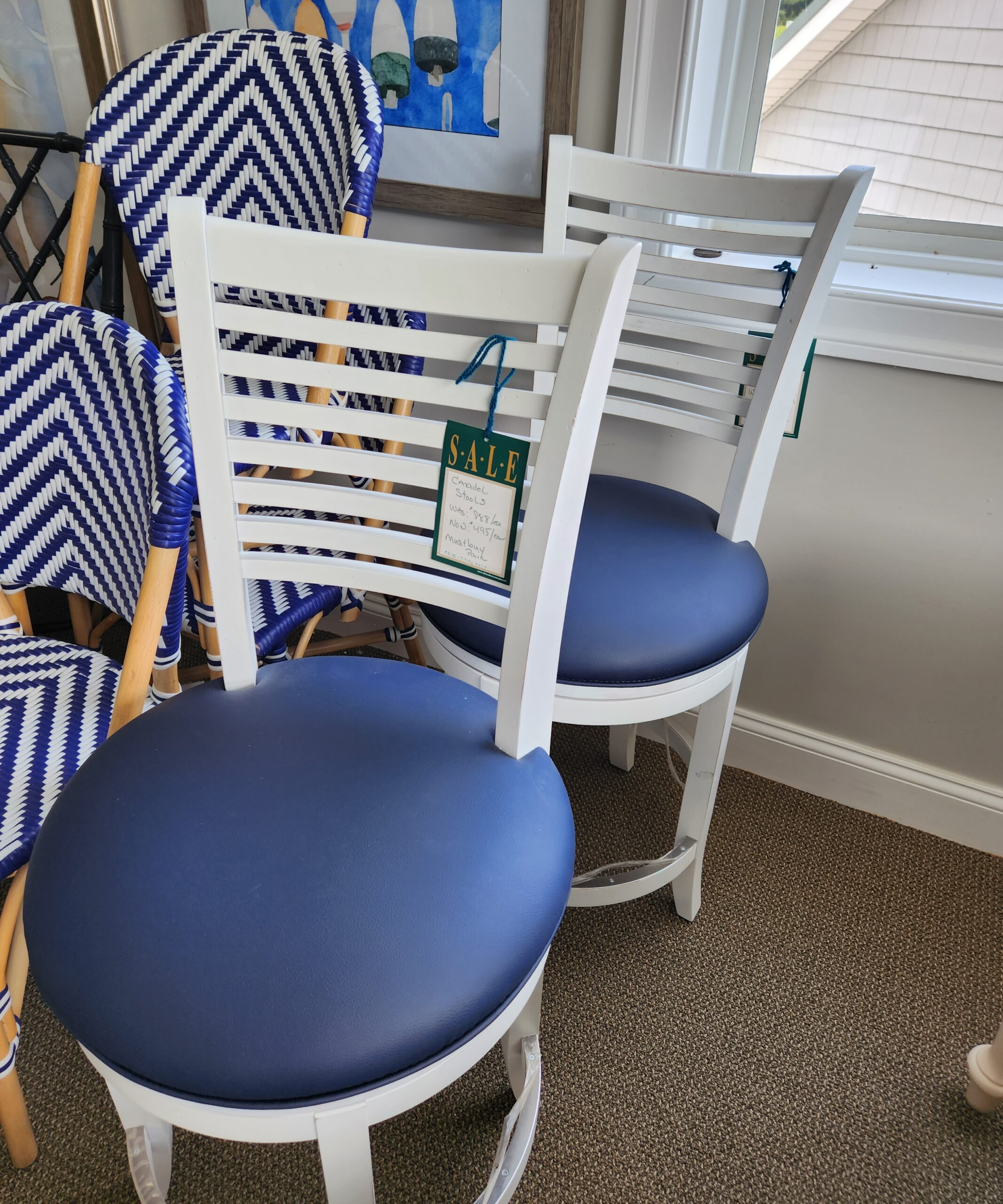 two white rocking chairs with blue cushions on them
