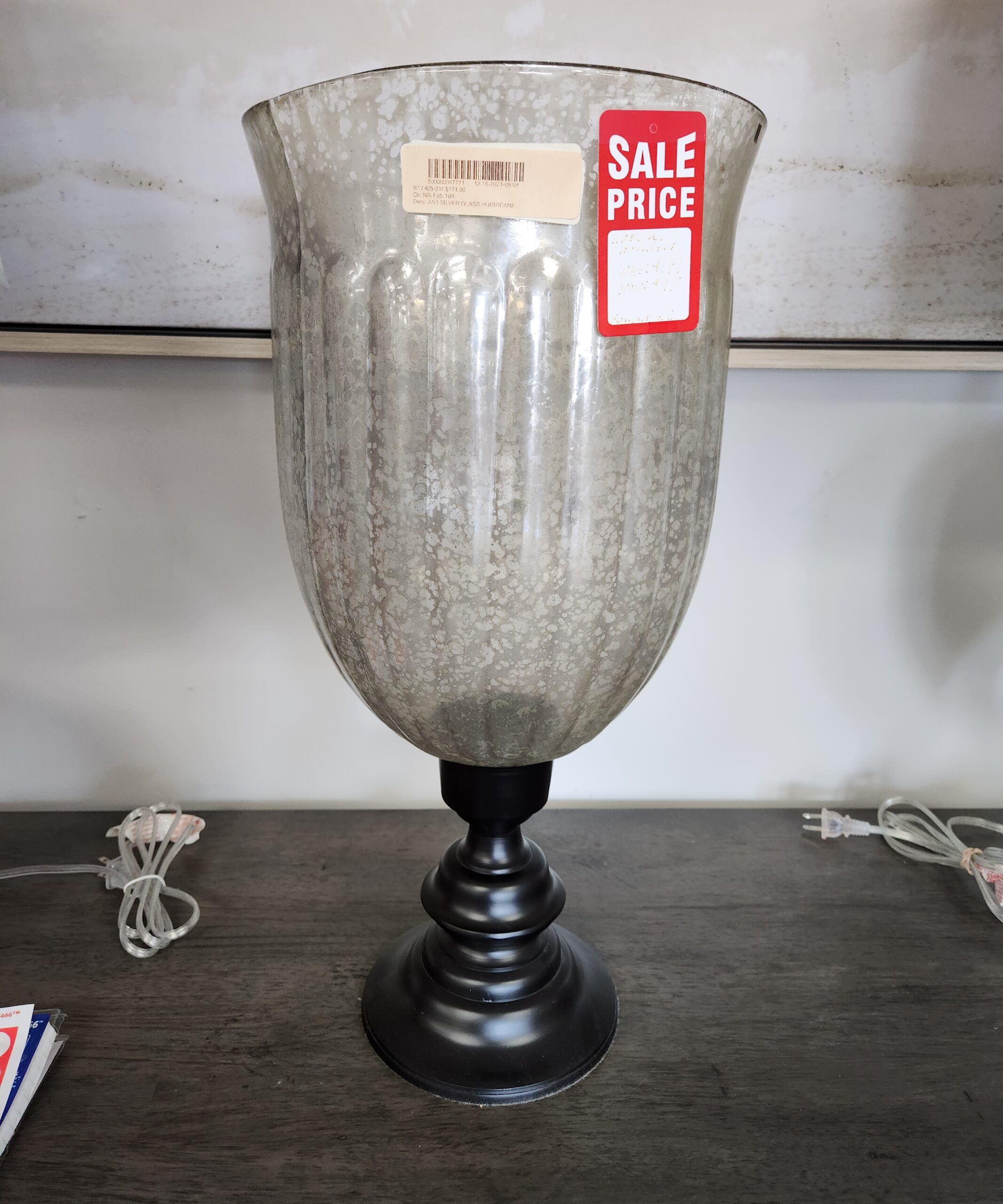 Antique Siler glass hurricane lamp on a table