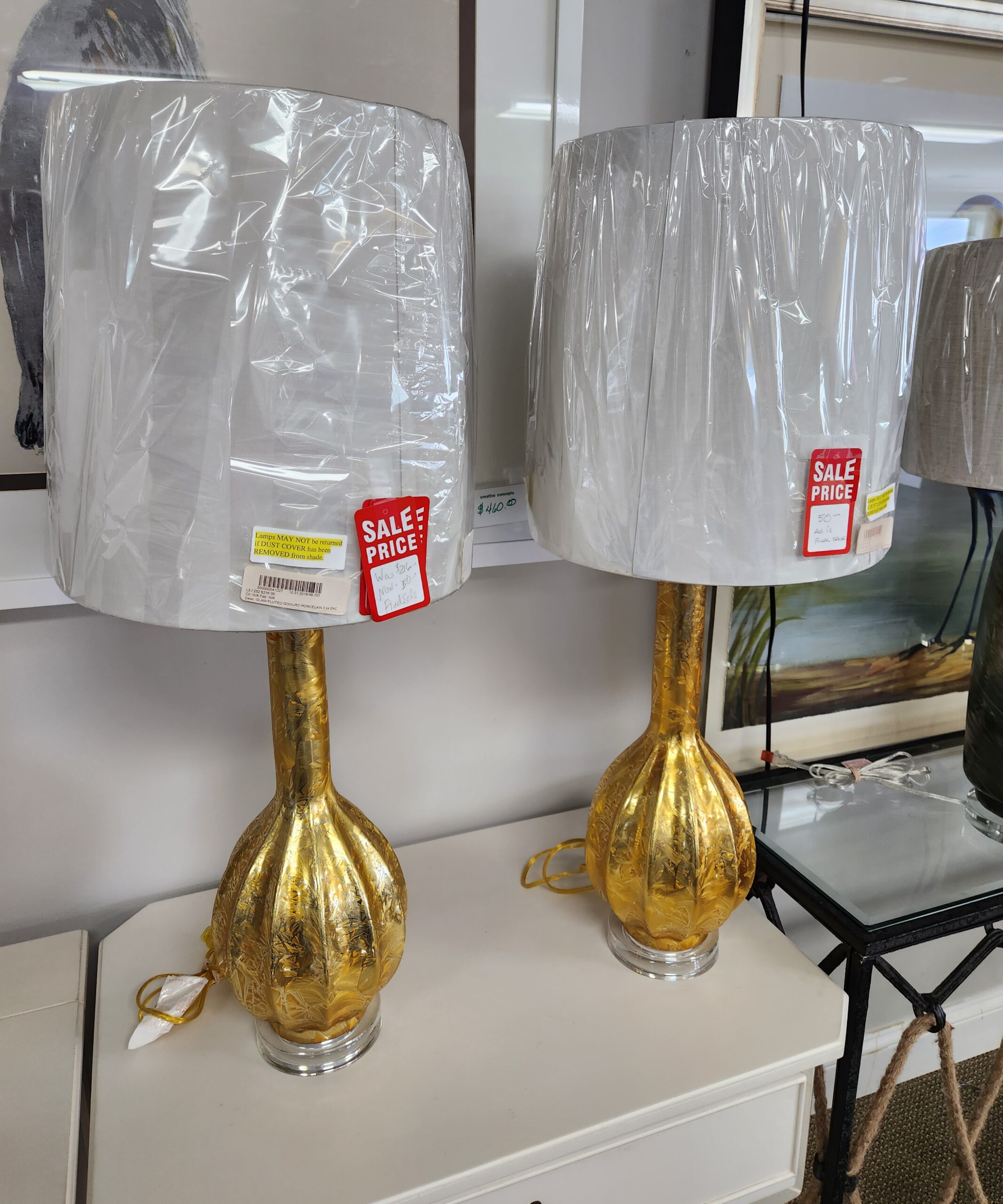 two gold lamps on the table