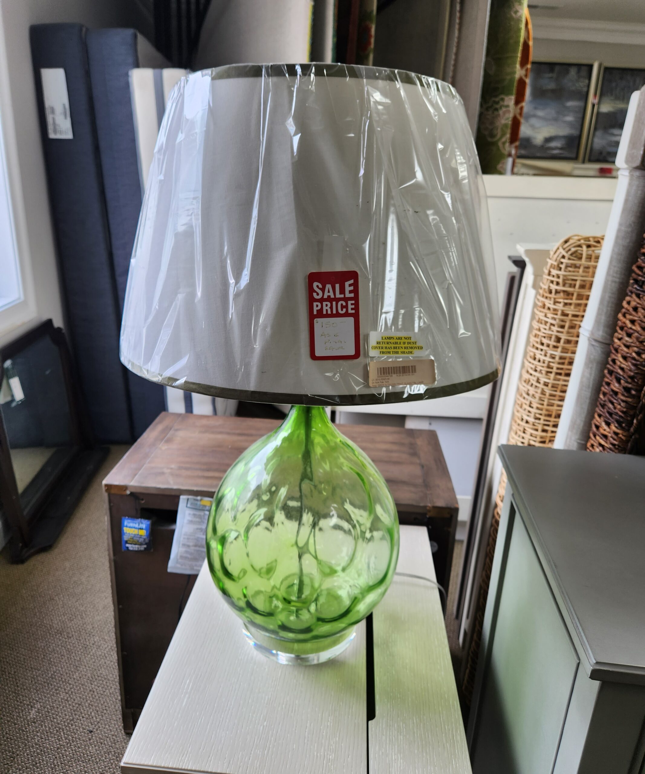 a green vase is on a table