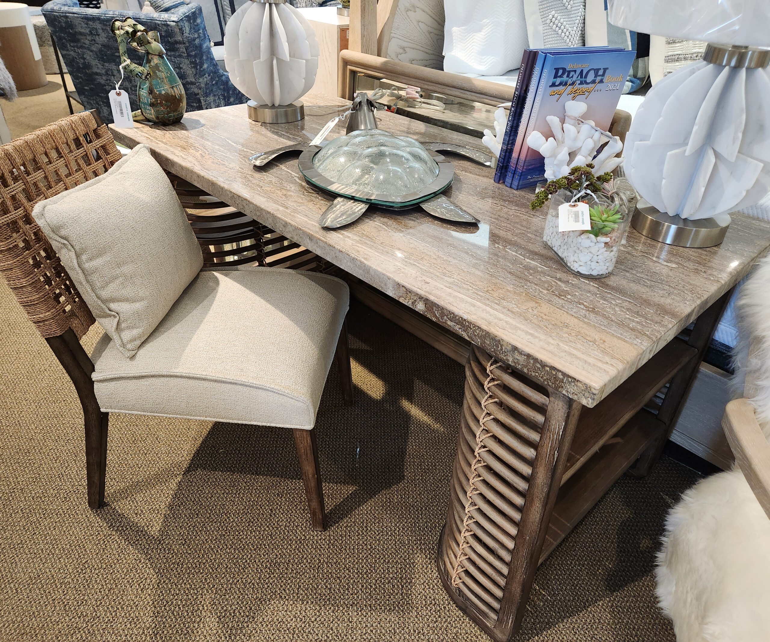 a wooden table topped with a mirror and two chairs