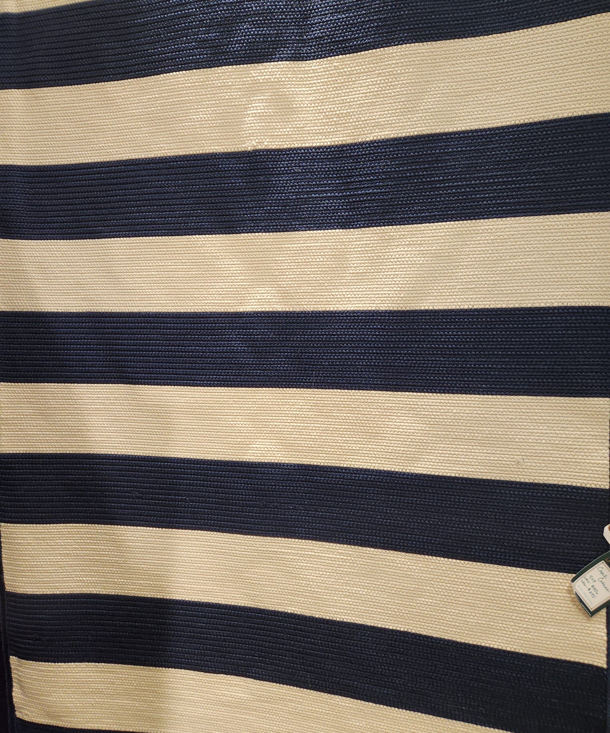 a striped bag with a tag on it