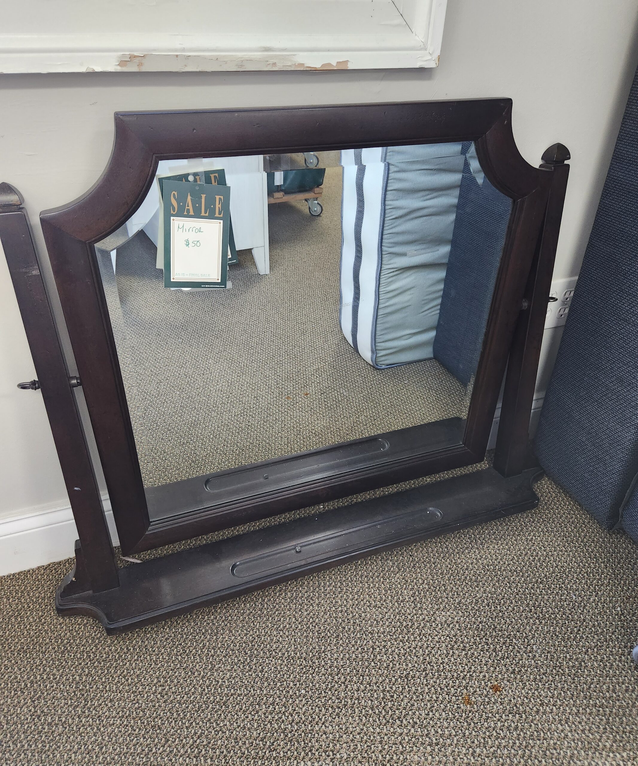 a mirror sitting on top of a wooden frame